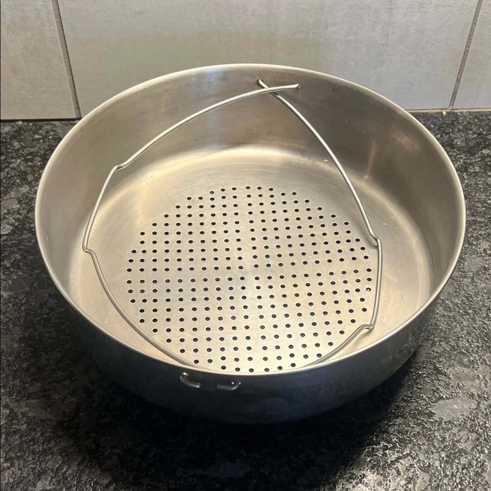 Stainless Steel Steamer Basket 9.5”. Has feet to sit above water to steam.